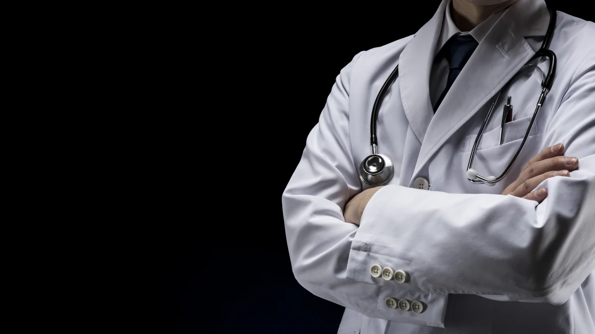 A physician in a white coat with a stethoscope.